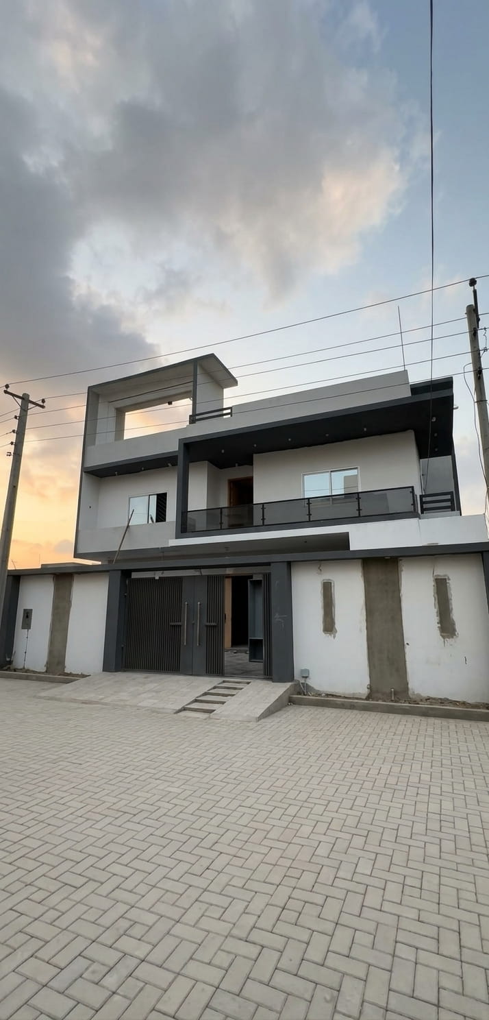 Three-storey residence with glass balustrade at dusk