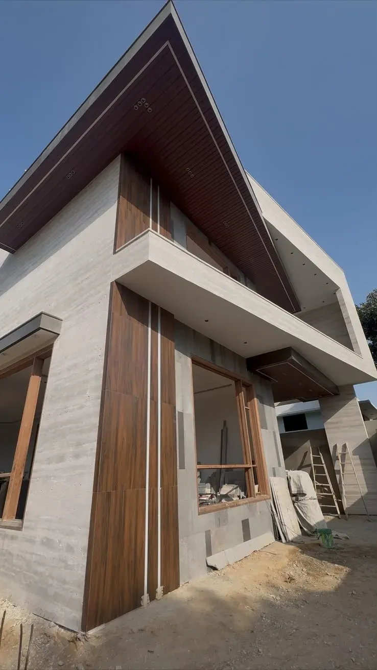 Modern two-storey house with stone and timber façade under construction finishing